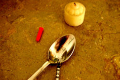 Candle and heroin spoon